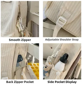 Detail view of smooth zippers, adjustable straps, and anti-theft pocket of beige backpack