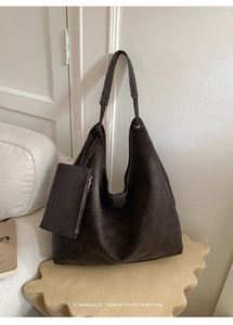 Detail of dark brown vintage suede tote bag with matching small zippered pouch