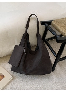 Close-up of retro large-capacity leather tote bag with a matching small zipper pouch