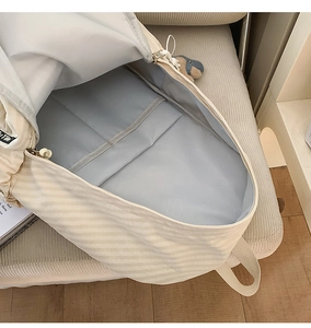 Close-up of spacious interior with laptop compartment and blue lining in checkered backpack
