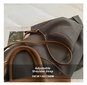 Detail of adjustable brown pebble leather strap with fine stitching and metal buckle