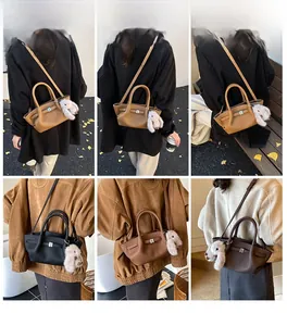 Detail view of four textured leather bucket bags in khaki black and brown with plush charms