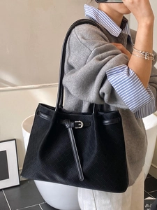 Chic black woven leather tote bag for women featuring a minimalist shoulder design