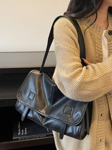 Retro black faux leather shoulder bag with flap design shown on a model
