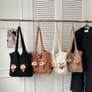 Hanging display of four knitted tote bags with cute 3D plush bear charms in various colors