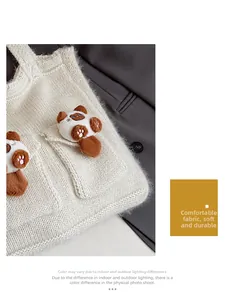 Detail of white knit tote bag with soft mohair texture and cute cat fur charms