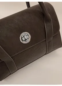 Detailed shot of retro brown tote bag featuring texture and silver twist lock closure