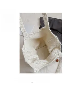 Macro view of cream knit tote bag showing thick texture and spacious interior