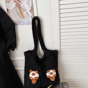 Detail of black plush tote bag featuring two 3D cat plush dolls on textured faux fur