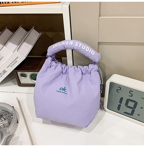 Detail of light purple nylon drawstring tote bag with褶皱 textures and branded handles