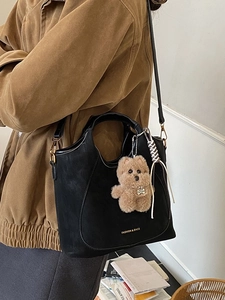 Retro black leather bucket bag with plush bear charm and detachable strap for daily commute