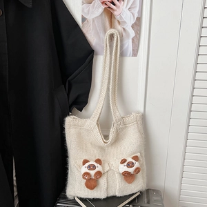 Detail of off-white knit shoulder bag featuring cute 3D plush cats and woven texture