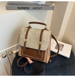 Detail of vintage leather backpack showing retro metal buckles and textured fabric