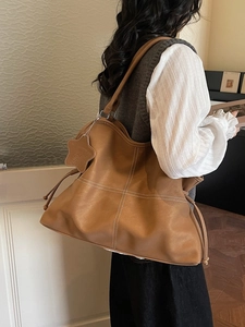 Retro brown leather tote bag with contrast stitching and star charm detail