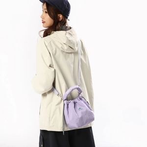 Detail of light purple drawstring bucket bag featuring white logo straps and nylon texture