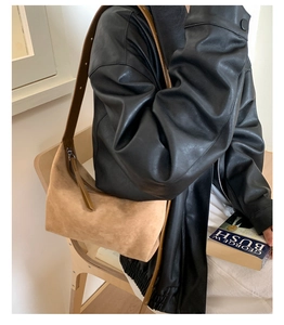 Close-up of hobo bag showing matte suede texture and adjustable leather shoulder strap