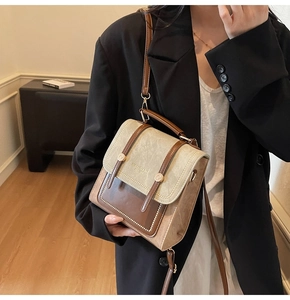 Detailed close-up of retro beige and brown color-block PU leather handbag texture