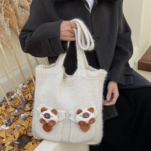 Detail of cream knit tote bag featuring 3D plush cat charms and thick soft texture