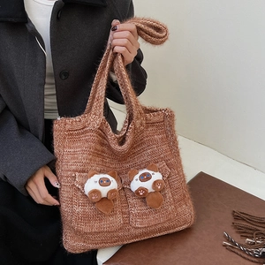 Brown knitted tote bag featuring cute plush cat pocket decorations and shoulder straps