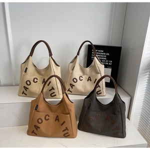 Detail showing high-capacity canvas tote bags with leather handles in four neutral colors
