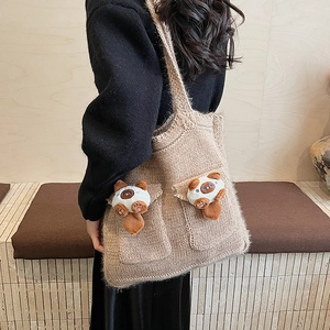 Detail of knitted tote bag in oatmeal beige featuring cute 3D cat plush pockets