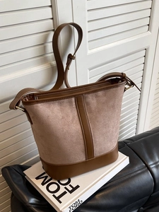 Retro brown suede bucket bag with contrast leather trim and adjustable shoulder strap