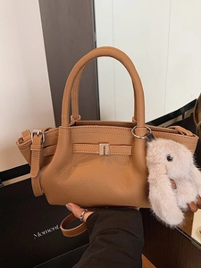 Brown faux leather bucket bag with litchi texture and a cute plush rabbit charm