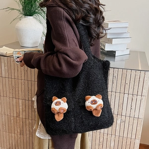 Detail shot of black plush tote bag with 3D cartoon bear decorations and soft texture