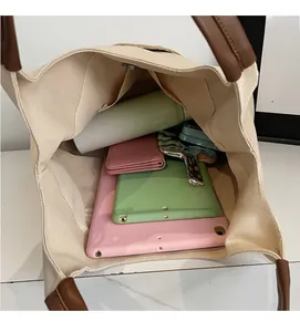 Top view of spacious interior of canvas tote bag filled with iPad and daily essentials