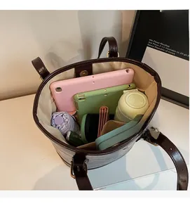 Interior view showing the large capacity of the dark brown leather bucket tote bag