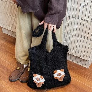 Detail of black faux fur tote bag featuring two 3D plush cartoon animals and a fluffy handle