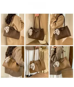 Detail view of large tote bags in dark brown and camel with plush rabbit pendants