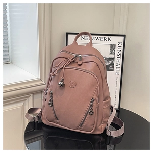 Close-up of litchi texture on dust pink backpack with detailed zippers and round logo