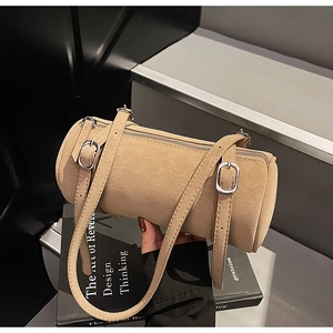 Detail view of the beige cylindrical shoulder bag with textured faux leather and silver buckles