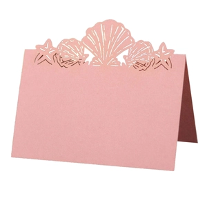 Pink laser-cut butterfly place card with shell and starfish ocean theme design