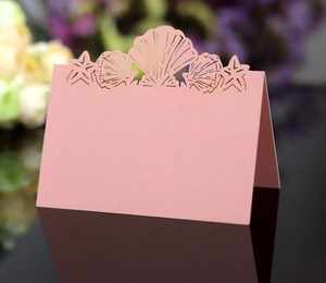 Detailed laser-cut sea shell and starfish place card for elegant table setting decor