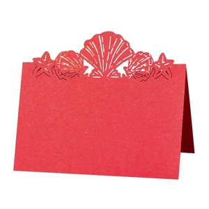 Detail of red laser cut sea shell and starfish place card with elegant folding design