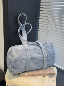 Retro light blue washed canvas boston tote bag with metallic detail on artistic background