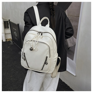 Rear view of a white lychee grain backpack on a model with drawstring and metal charm detail