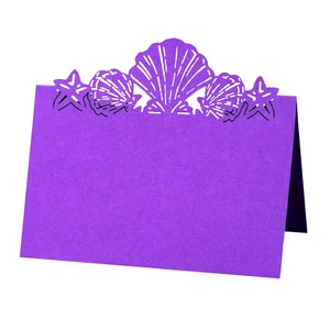 Detail of purple laser cut shell and starfish ocean theme wedding place card