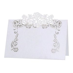 Elegant white laser-cut floral place card with hollow rose pattern for table seating