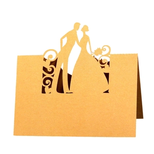 Laser cut hollow wedding place cards with bride and groom silhouette in kraft paper