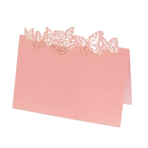 Pink laser-cut butterfly place cards made of pearlescent paper for wedding table decor