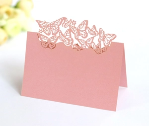 Macro shot of 3D laser-cut butterfly hollow place card with elegant folding structure