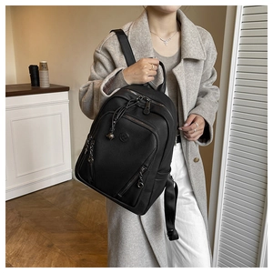 Detail of black pebbled leather backpack with sturdy zippers and nylon shoulder straps