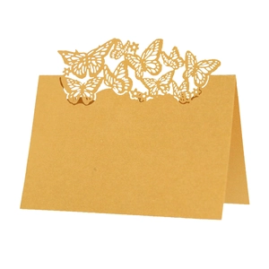 Macro shot of 3D laser-cut butterfly hollow place cards in a golden folding design