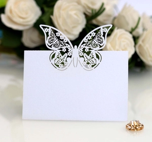 Detailed laser-cut butterfly place card for wedding table decor on white paper