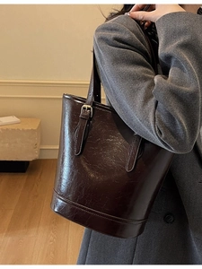 Minimalist coffee brown bucket bag in glossy cracked leather for women's daily commute