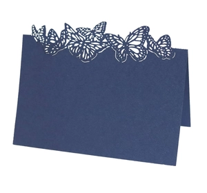 Detail of dark blue table card featuring laser-cut butterfly patterns on high-quality paper