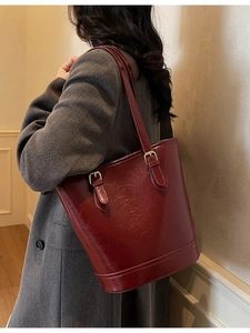 Minimalist burgundy glossy leather bucket bag with gold buckle for autumn winter commute